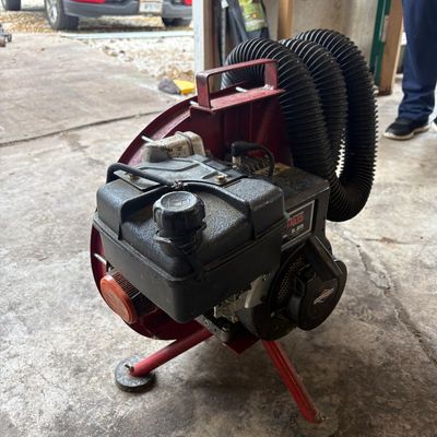 Sale Photo Thumbnail #52: Briggs & Stratton 5.25 HP engine-powered bee vacuum blower attachment with flexible black hoses and a red metal frame.