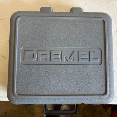 Sale Photo Thumbnail #41: Vintage grey plastic Dremel rotary tool carrying case with molded logo and black handle.