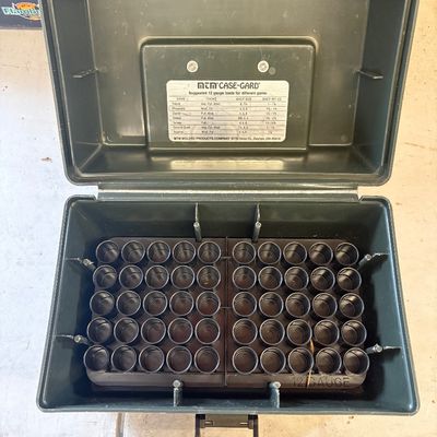 Sale Photo Thumbnail #50: Open MTM Case-Gard olive green plastic shotgun shell box featuring an internal tray for 50 12-gauge shells and a reference chart inside the lid.