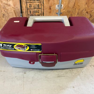 Sale Photo Thumbnail #47: Plano Tackle Systems single-tray fishing tackle box in maroon and light gray plastic, featuring a folding top handle and front latch closure.