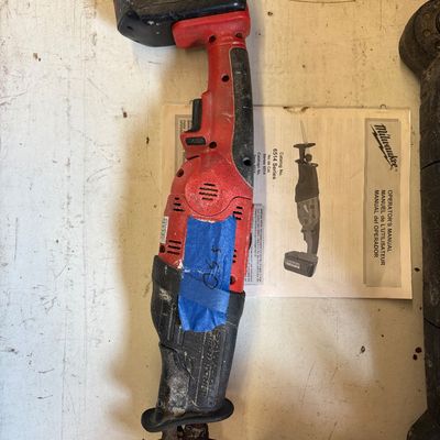 Sale Photo Thumbnail #34: Milwaukee Sawzall Hatchet 18V cordless reciprocating saw with battery and operator's manual.