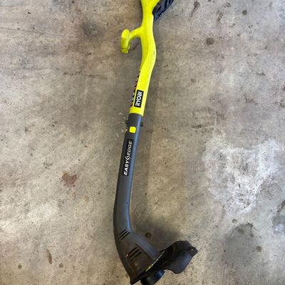 Sale Photo Thumbnail #37: Ryobi EasyEdge cordless string trimmer, showing some cosmetic wear from use.