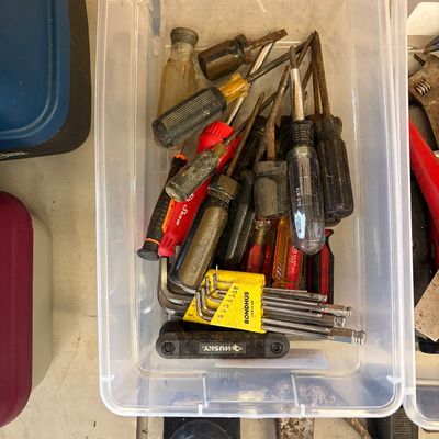 Sale Photo Thumbnail #15: Clear plastic storage bin filled with assorted hand tools, including various screwdrivers, Allen wrenches, and a Husky folding hex key set.