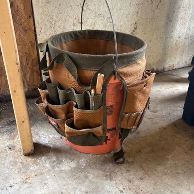 Sale Photo Thumbnail #12: Bucket Boss canvas tool organizer sleeve fitted over a five-gallon plastic bucket, showing moderate wear from use.