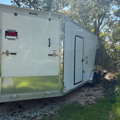 Sale Photo Thumbnail #71: Large white enclosed dual-axle cargo trailer with diamond plate trim and a side access door.