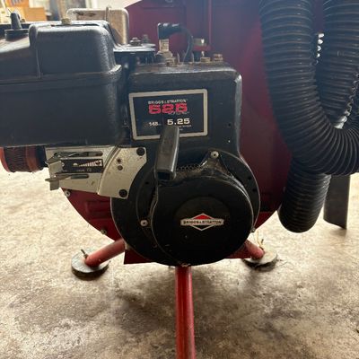 Sale Photo Thumbnail #51: Briggs & Stratton 525 Series 148cc engine attached to a red heavy-duty vacuum system, showing light wear from use.