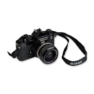 Sale Photo Thumbnail #361: Nikon FE Black 35mm SLR Camera with 24mm Nikkor Lens and Case