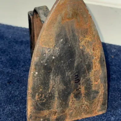 Sale Photo Thumbnail #598: Antique cast iron sad iron, featuring heavy surface rust and patina from age.