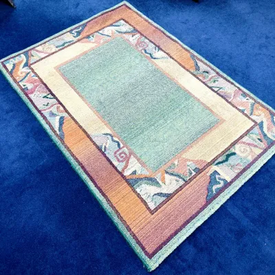 Sale Photo Thumbnail #65: Postmodern area rug featuring a light blue-green central field and a multi-colored geometric border in shades of terracotta, mauve, and cream.