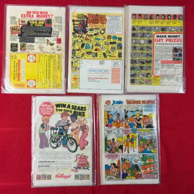 Sale Photo Thumbnail #763: Lot of five vintage comic books in protective plastic sleeves, displaying vintage back cover advertisements from the 1970s.