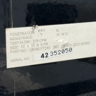 Sale Photo Thumbnail #540: Close-up of a specification sticker on an industrial air filter, displaying penetration, resistance, test flow, size, part number, and serial number.