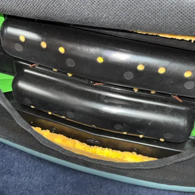 Sale Photo Thumbnail #242: Close-up view of a chair or vehicle seat frame revealing inner plastic supports, wires, and exposed yellow cushion foam through a torn fabric seam.