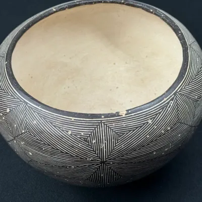Sale Photo Thumbnail #134: Acoma Pueblo black-on-white fine-line pottery bowl featuring detailed geometric starburst patterns, showing light surface wear along the rim.