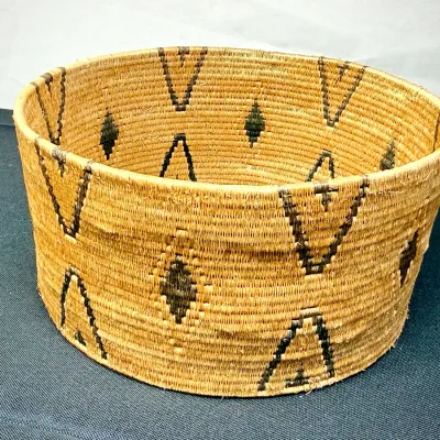 Sale Photo Thumbnail #380: Hand-woven Native American style coiled basket featuring geometric diamond and chevron motifs in dark fiber.