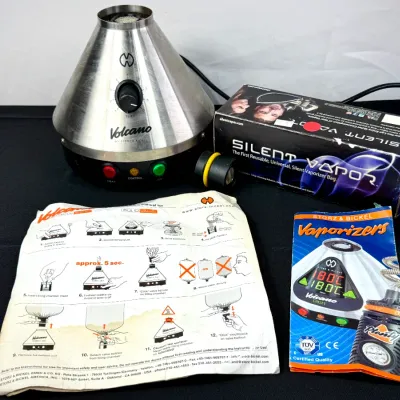Sale Photo Thumbnail #90: Storz & Bickel Volcano Classic tabletop vaporizer set, including the stainless steel cone unit, a boxed Silent Vapor accessory, and original paper manuals.