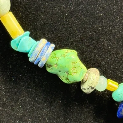 Sale Photo Thumbnail #339: Close-up detail of a colorful beaded necklace featuring genuine green and blue turquoise nuggets, lapis disc beads, and yellow accents.