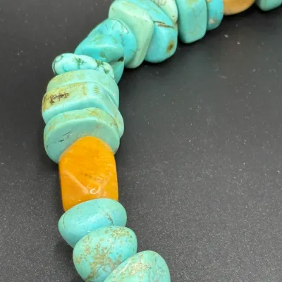 Sale Photo Thumbnail #350: Close-up of a Southwest-style necklace strung with natural turquoise nuggets and accent stone beads.