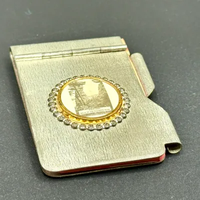 Sale Photo Thumbnail #197: Vintage metal notepad holder featuring a central round emblem with an image of Stand Rock, Dells of the Wisconsin River.