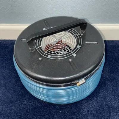 Sale Photo Thumbnail #545: Vintage Filter Queen canister vacuum base featuring a textured black lid, integrated carrying handle, and blue ribbed body, appearing in good, functional condition.