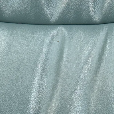 Sale Photo Thumbnail #229: Close-up detail of light blue leather upholstery showing subtle creasing and texture.