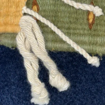 Sale Photo Thumbnail #426: Extreme close-up detail of a hand-woven wool tapestry featuring cream-colored fringe, yellow, and green yarn.