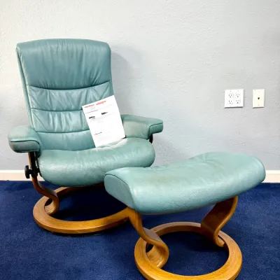 Sale Photo Thumbnail #219: Teal leather Stressless-style reclining armchair with matching swivel ottoman and bentwood bases.