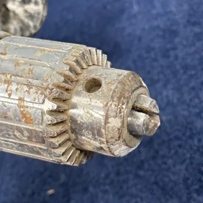 Sale Photo Thumbnail #613: Vintage metal drill chuck showing surface rust, grime, and wear from age and use.