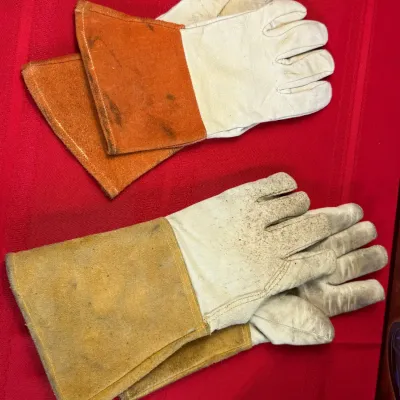 Sale Photo Thumbnail #522: Two pairs of heavy-duty leather welding gloves showing light wear and staining.