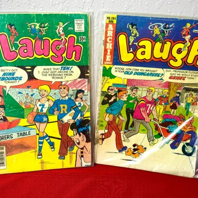 Sale Photo Thumbnail #760: Two vintage Archie Series Laugh comic books, including No. 314 from May and No. 284 from November, both bagged and boarded with visible spine wear.