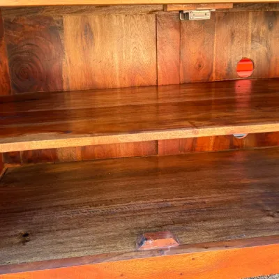 Sale Photo Thumbnail #312: Interior compartment of a solid wood entertainment console, featuring an adjustable shelf, rich natural grain, and a pre-drilled media hole in the back panel.