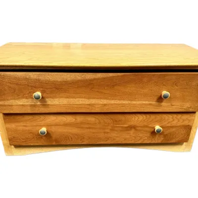 Sale Photo Thumbnail #66: Two-drawer low wooden chest with round wooden knobs and a light natural finish.