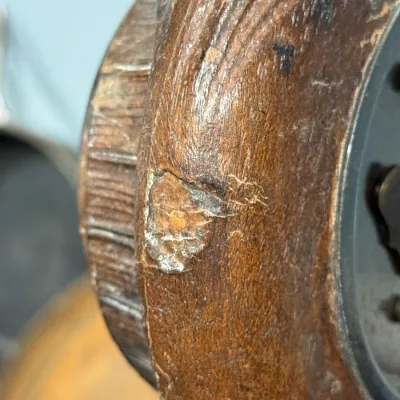 Sale Photo Thumbnail #401: Extreme close-up showing a chip and surface wear on the dark stain of a carved wooden object or frame.