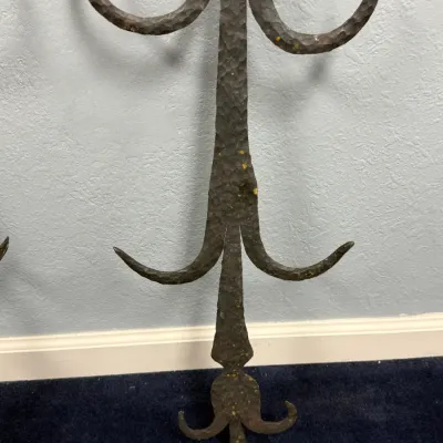 Sale Photo Thumbnail #642: Hand-hammered wrought iron wall sconce or decorative finial featuring scrolled accents and a rustic, dark patina.