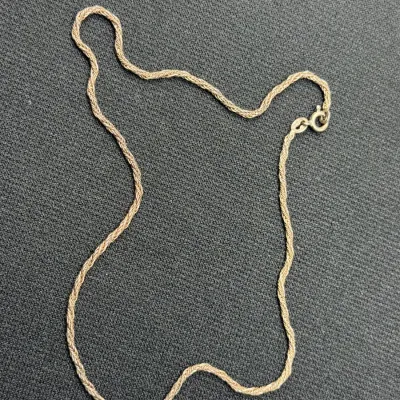 Sale Photo Thumbnail #181: Fine gold-tone rope chain necklace featuring a delicate woven design and a spring-ring clasp.