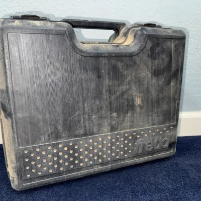 Sale Photo Thumbnail #630: Freud black plastic hard carrying case, showing heavy surface wear and dust.