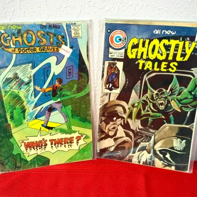 Sale Photo Thumbnail #779: Two Charlton Comics horror titles in protective sleeves, including The Many Ghosts of Doctor Graves #38 from May 1973 and Ghostly Tales #117 from September 1975.
