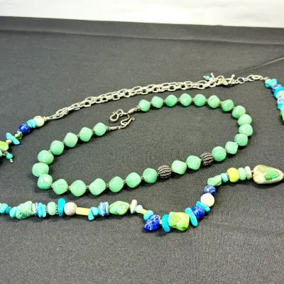 Sale Photo Thumbnail #333: Two beaded necklaces featuring turquoise, lapis lazuli, green adventurine, and silver-tone accents.