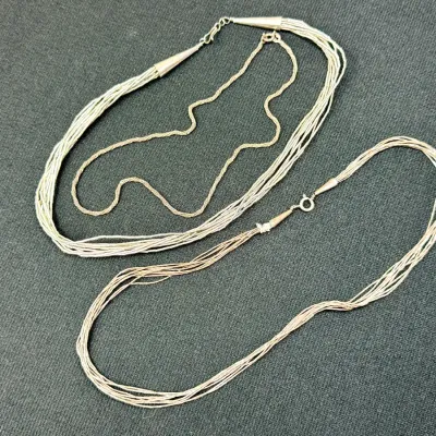 Sale Photo Thumbnail #7: Trio of sterling silver necklaces, including two multi-strand Southwestern liquid silver necklaces and a delicate chain.