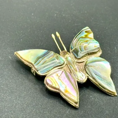 Sale Photo Thumbnail #185: Vintage sterling silver and abalone shell butterfly brooch featuring iridescent carved wings.