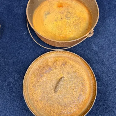 Sale Photo Thumbnail #590: Vintage cast iron Dutch oven with lid, marked size 14, displaying surface rust and a wire bail handle.