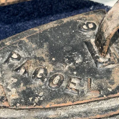 Sale Photo Thumbnail #596: Antique cast iron sad iron featuring raised 'PAGOEL' branding and number 6 marking, showing heavy patina and age-appropriate rust.