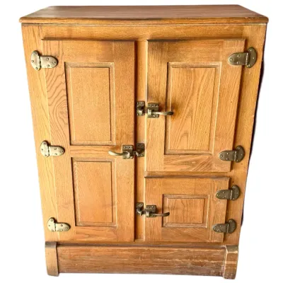 Sale Photo Thumbnail #15: Antique oak three-door ice box cabinet featuring paneled doors and original brass hardware, circa early 20th century.