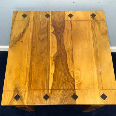 Sale Photo Thumbnail #736: Rustic solid wood end table featuring a planked tabletop with dark metal diamond-shaped inlay accents and a natural grain finish.