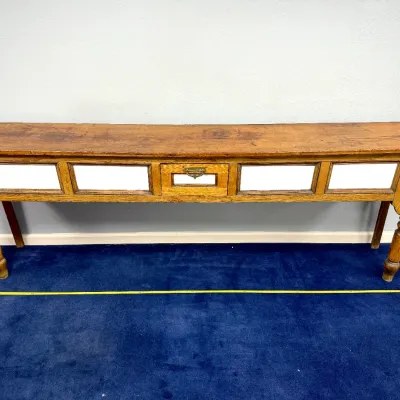 Sale Photo Thumbnail #275: Antique rustic oak console table featuring a center drawer with brass card holder hardware and white side panels.
