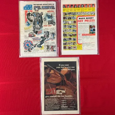 Sale Photo Thumbnail #783: Trio of vintage 1970s comic books in protective sleeves, featuring retro back-cover advertisements for Evel Knievel toys, American Seeds, and Daisy B-B guns.