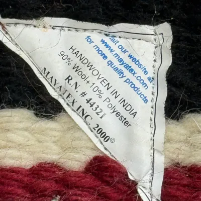 Sale Photo Thumbnail #442: Manufacturer tag for a Mayatex wool saddle blanket, indicating a handwoven wool blend made in India.
