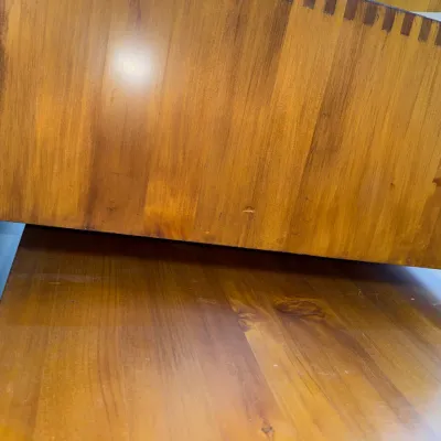 Sale Photo Thumbnail #218: Close-up of a wooden furniture drawer showcasing dovetail joinery and a warm honey-oak finish.