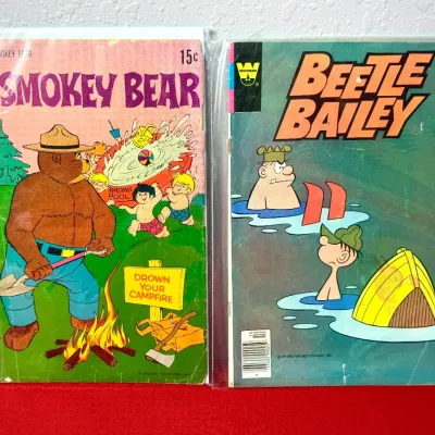 Sale Photo Thumbnail #814: Pair of vintage Whitman comic books featuring Smokey Bear and Beetle Bailey, bagged for protection.