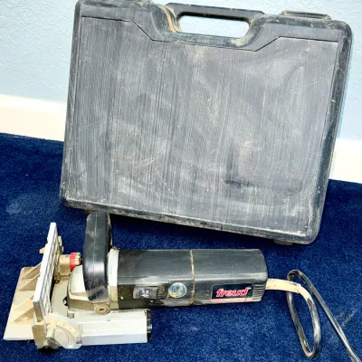 Sale Photo Thumbnail #622: Freud electric biscuit joiner power tool with its original black hard plastic carrying case.