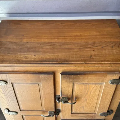 Sale Photo Thumbnail #265: Vintage oak icebox cabinet featuring heavy brass latching hardware and paneled doors.